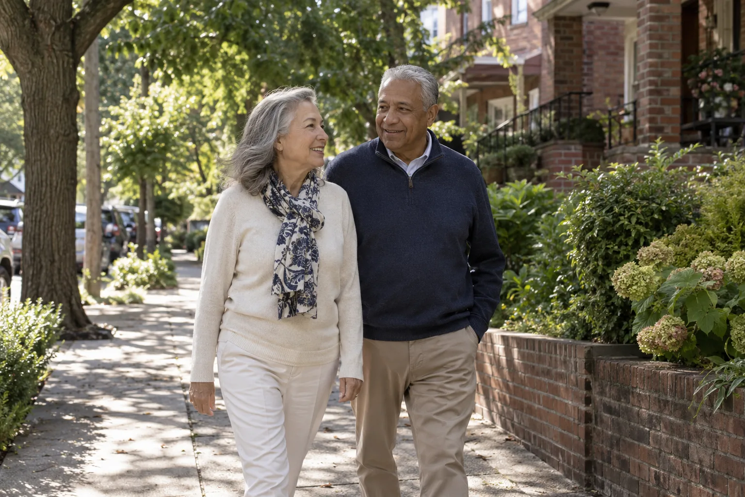 Mature adults walking along a leafy neighborhood sidewalk