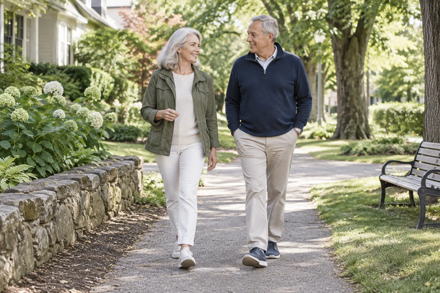 Two adults walking together on a leafy neighborhood path